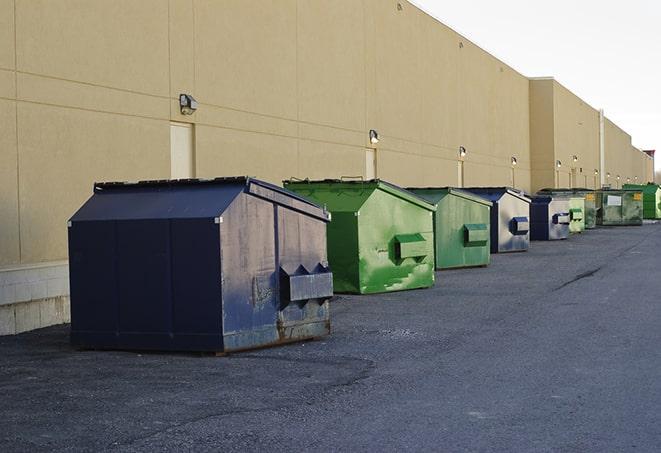 large construction dumpster positioned on a city street in Ganado TX